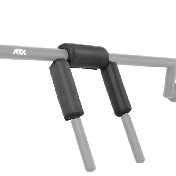 The ATX® Safety Squat Bar Pads feature a gray metal bar with three black cylindrical foam grips for comfortable exercise handholds. The ATX logo is displayed, and perpendicular bars extend outward for additional grip options.