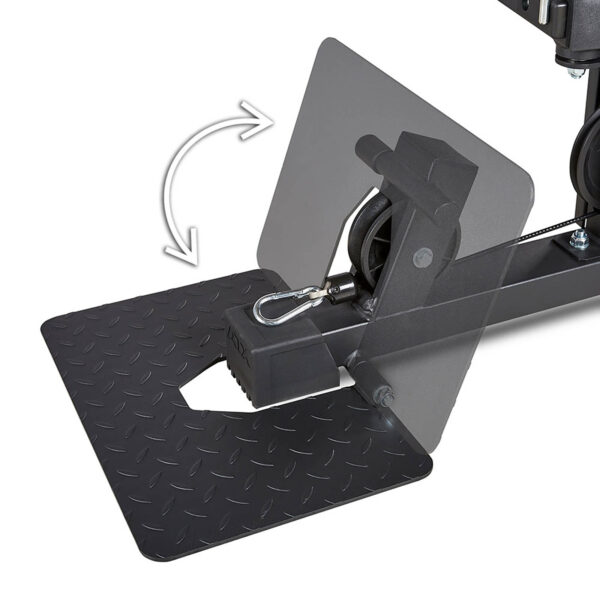 Close-up of the ATX® MultipleX Multi Gym - 700s black metal pedal mechanism, featuring a textured surface and a hook attachment. An arrow indicates its swiveling motion, with clear panels displaying internal components.