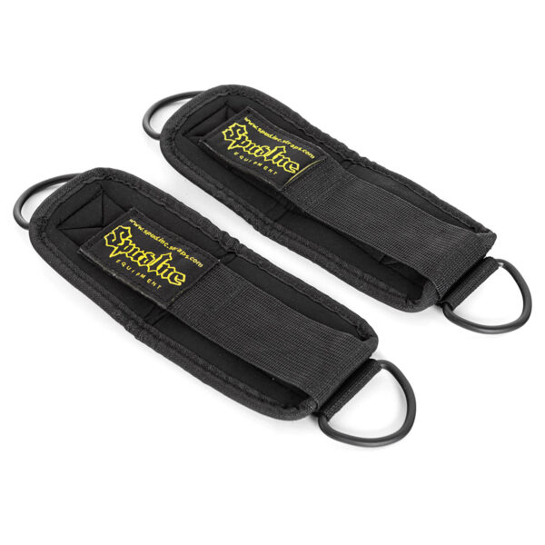 The Spud Ankle Cuff Pair features two black ankle straps with D-ring attachments, yellow lettering on the label, adjustable closures, and padded design for comfort, ideal for fitness and exercise equipment use.