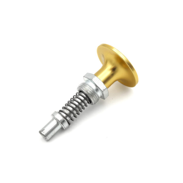 The image displays the Pop Pin M20 6933, a metal mechanical component featuring a gold circular knob, a threaded bolt, and a spring mechanism, slightly angled against a plain white backdrop.