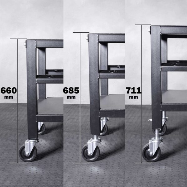 Three images of the Ironmaster QLDB Stand PRO, a metal cart with wheels, are displayed side by side showcasing it at heights of 660 mm, 685 mm, and 711 mm. The floor has patterned grey tiles and the cart features two sturdy shelves.