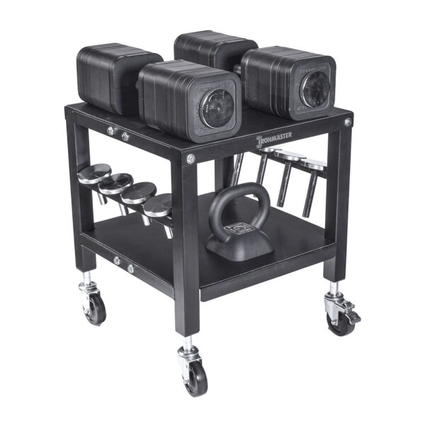 The Ironmaster QLDB Stand PRO, a black multi-level rolling cart, holds four Ironmaster adjustable dumbbells on top, a kettlebell on the second shelf, and several accessories on side hooks. Its equipped with wheels for easy movement.