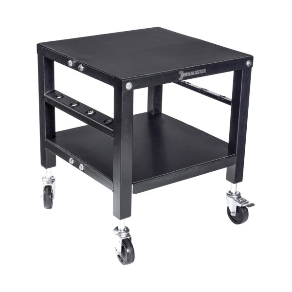 The Ironmaster QLDB Stand PRO is a sturdy black equipment cart with a square design, featuring a flat top surface for adjustable dumbbells, a lower shelf, four swivel casters for easy mobility, and a side rack for accessory storage.