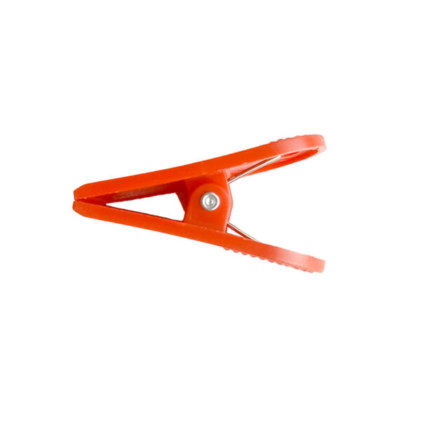 The Treadmill Safety Key Clip, made of red plastic with a metal spring, is shown against a white background. It is open to reveal its simple and functional gripping mechanism.