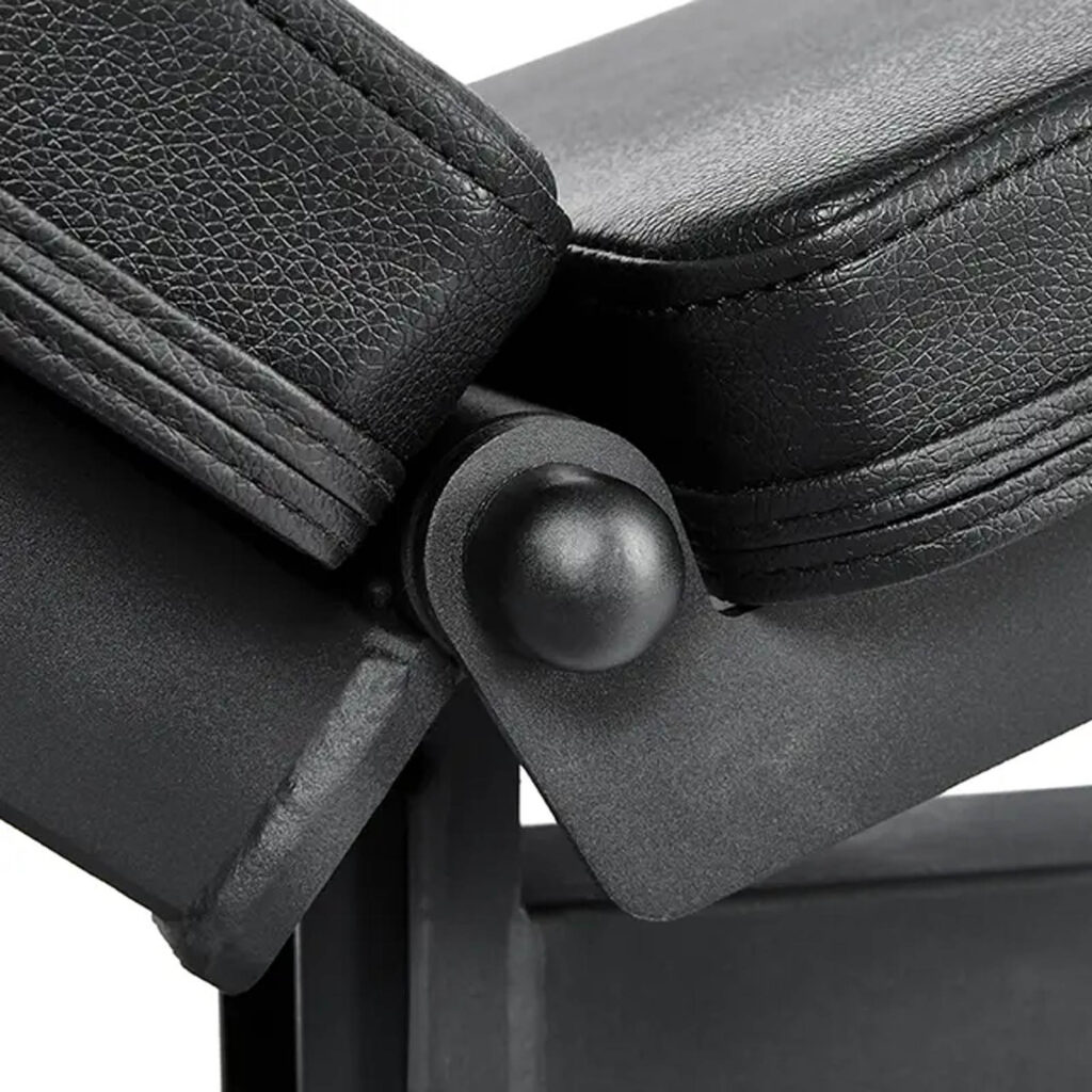 Close-up of the ATX® Commercial FID Bench ATX-MBX-660, a black adjustable flat incline bench with two padded sections connected by a hinge joint. It features a textured, leather-like surface.