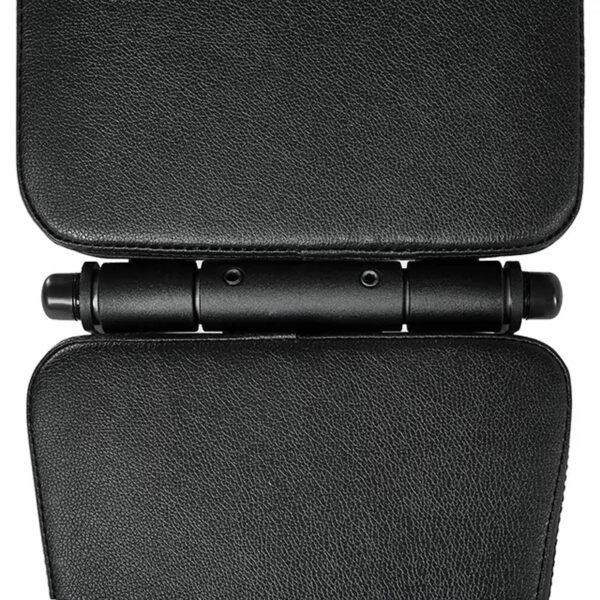Close-up of a black, textured hinge connecting two padded sections on the ATX® Commercial FID Bench ATX-MBX-660. The hinge features three cylindrical bars and two screws, seamlessly aligning the parts. The material resembles leather or synthetic fabric for durability and style.