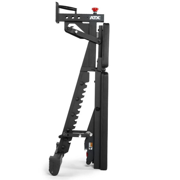 Side view of the folded ATX® Commercial FID Bench ATX-MBX-660, highlighting its compact design as a flat incline bench in black with multiple adjustment levers and wheels for easy mobility.