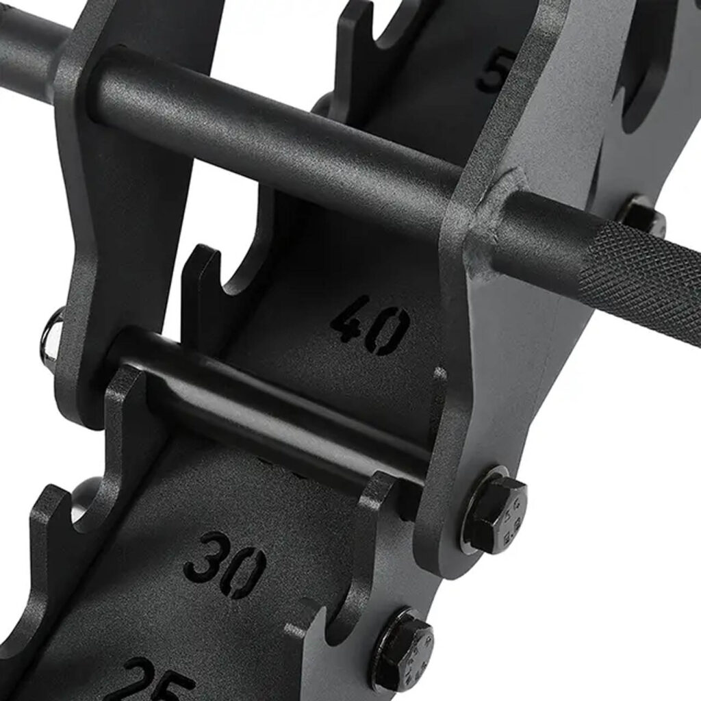 A black adjustable dumbbell set is shown on a rack next to an ATX® Warrior Bench 2.0, with weight increments of 25, 30, and 40. The dumbbell features a textured grip and sits in a metal cradle.