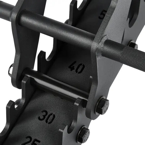 A black adjustable dumbbell set is shown on a rack next to an ATX® Warrior Bench 2.0, with weight increments of 25, 30, and 40. The dumbbell features a textured grip and sits in a metal cradle.