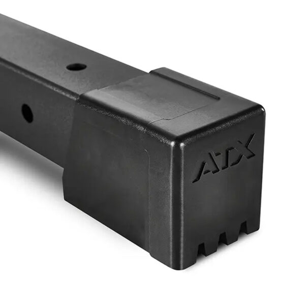 Close-up of a black metal bar with ATX on the protective end cap, part of the ATX® Smith Machine 500 designed for low ceilings (198 cm), featuring multiple holes along its length indicating modular or adjustable use.