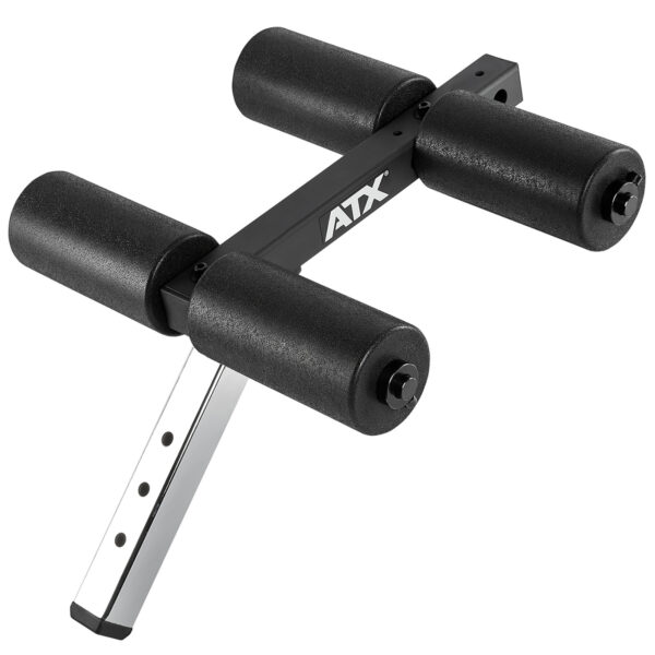 The ATX® AB Attachment is a black adjustable foam roller for a workout bench, featuring four cylindrical foam pads on a metal frame to support exercises.