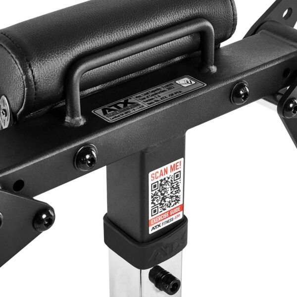 Close-up of a black ATX® Pec-Fly Attachment showing padded support, metal structure, and visible screws. A QR code labeled Scan Me! Exercise Guide is on the metal bar beneath the padding.