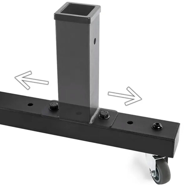 Close-up of an ATX® Attachment Storage Rack, featuring a black metal stand with a square vertical post and a horizontal base on casters. Two arrows indicate adjustment or movement directions.