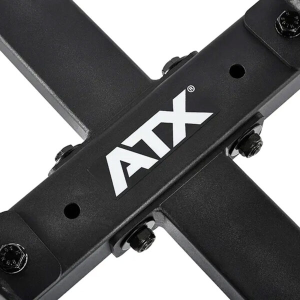 Close-up of the ATX® Attachment Storage Rack, a black metal structure with intersecting bars and a white ATX logo in the center, secured with bolts.