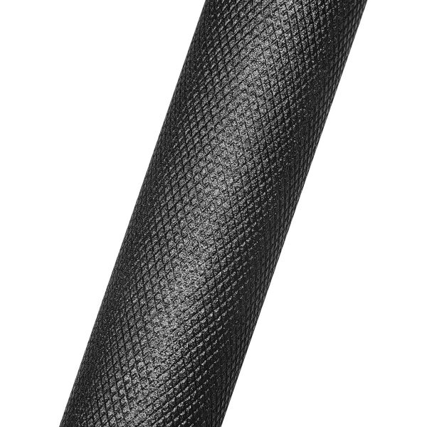 Close-up of a textured, black cylindrical object with a diagonal crosshatch pattern. The surface is shiny and appears to have a grip-like texture.