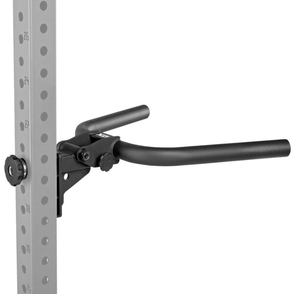 Close-up of a black dip bar attachment mounted on a grey, perforated gym rack. The attachment features two parallel handles for performing dips, secured with a knob.