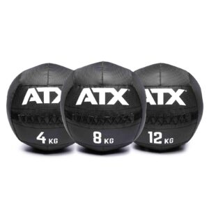 Three black ATX® Wall Balls PVC are lined up side by side with weights of 4 kg, 8 kg, and 12 kg. They each feature visible stitching and a textured surface.