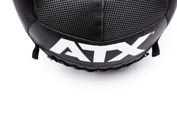 A close-up of a black and gray textured ATX® Wall Ball PVC shows ATX in white. The ball features stitching details and black straps, set against a white background.