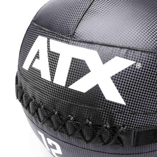 Close-up of a black textured ATX® Wall Balls PVC medicine ball, featuring bold white ATX initials and visible cross-stitch detailing for a durable look.