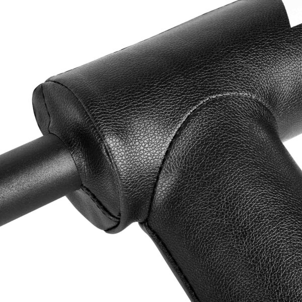 Close-up of a black massage gun with a textured handle, showcasing its ergonomic design. The image highlights the durable leatherette material and stitching details around the attachment area, reminiscent of a squat bar with handles for enhanced grip and comfort.