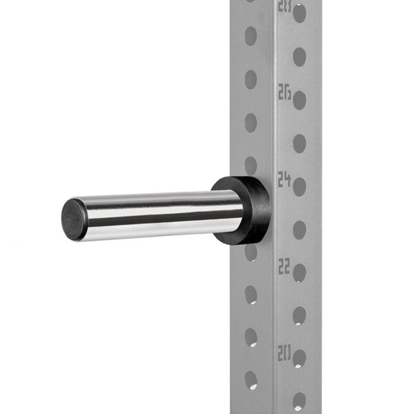A silver barbell holder is attached to a gray, perforated metal frame with numbered holes for adjustable height settings. The frame features black retaining rings, while the holder extends horizontally.