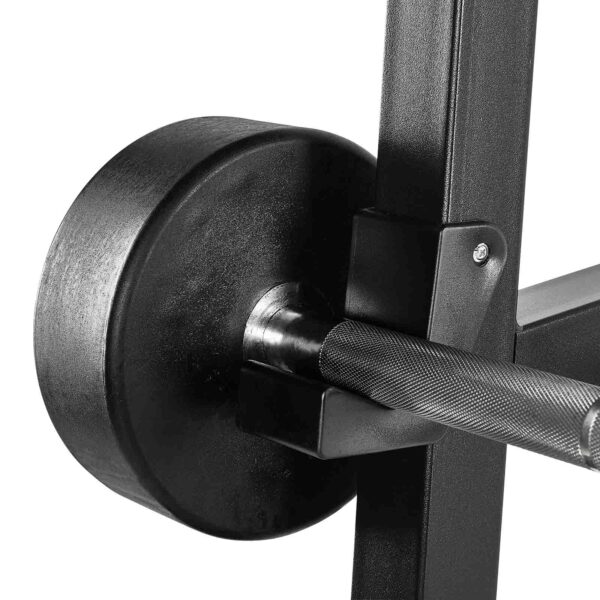 A close-up of a textured barbell with a heavy black weight plate securely attached rests on the Wall Mounted Barbell Rack, showcasing its sturdy metal construction and sleek finish.