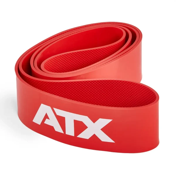 A red ATX® Latex Free Resistance Band - 9 Levels, featuring a textured surface, is coiled neatly. The letters ATX are prominently printed in white on the side of this gym resistance band, which sits against a plain white background, ready for your training sessions.