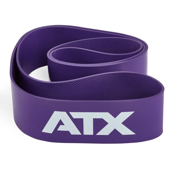 A coiled purple ATX® Latex Free Resistance Band, featuring white letters on its surface, forming an S-shape.
