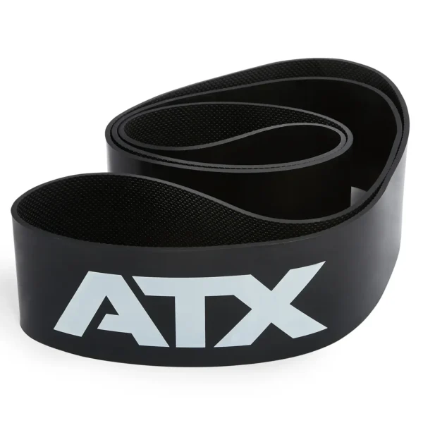 An ATX® Latex Free Resistance Band, featuring a coiled black design with "ATX" printed in white on the side, is rolled and resting on a white surface. It's perfect for enhancing your training routine.