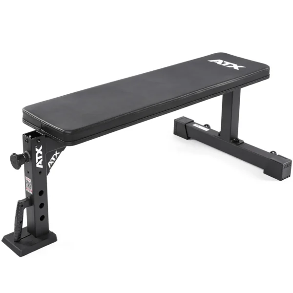 The ATX® Flat Workout Bench Attachment is ideal for strength training, featuring a black padded top, adjustable height settings, and sturdy metal legs. The brand name ATX is displayed in white on both the padding and side.
.