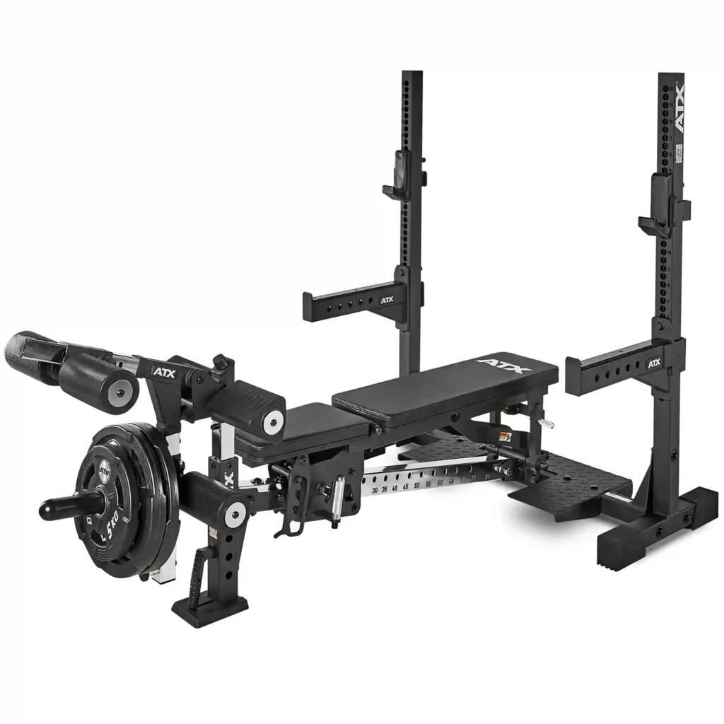 The ATX® Adjustable Bench Press is a black, multifunctional strength training bench with adjustable supports, a padded bench, leg attachment, and weight storage.