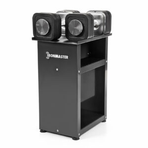 A set of Ironmaster Quick-Lock Adjustable Dumbbells rests on a sleek, modern black stand with visible weight markings. This sturdy, compact stand has two shelves for storage, perfect for organized fitness enthusiasts.