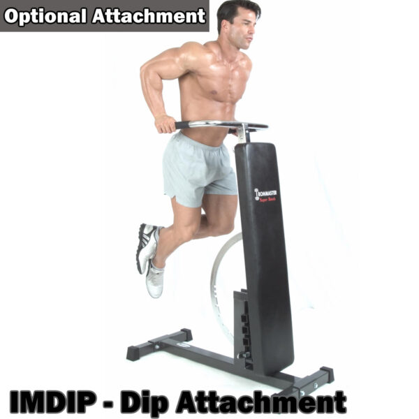 A man, wearing gray shorts and athletic shoes, uses the IMDIP - Dip Attachment labeled as an Optional Attachment on a fitness machine and a weight bench set. Hes performing a dip with arms extended using the Ironmaster Super Weights Bench.