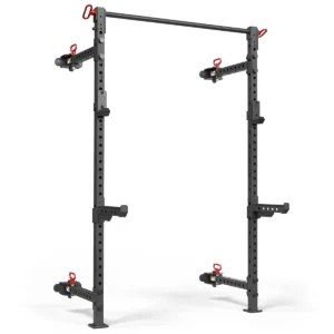 The ATX® Folding Squat Rack 500, featuring sleek black design with adjustable red safety catches and J-hooks, stands against a white background. Ideal for barbell exercises and strength training, it offers convenience without losing functionality.