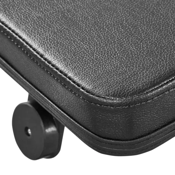 The precision of the ATX® Cable Lat Pull Down Machine is mirrored in the expertly crafted wheel design and textured black leather corner of a suitcase, showcasing meticulous stitching and a sleek metal wheel.