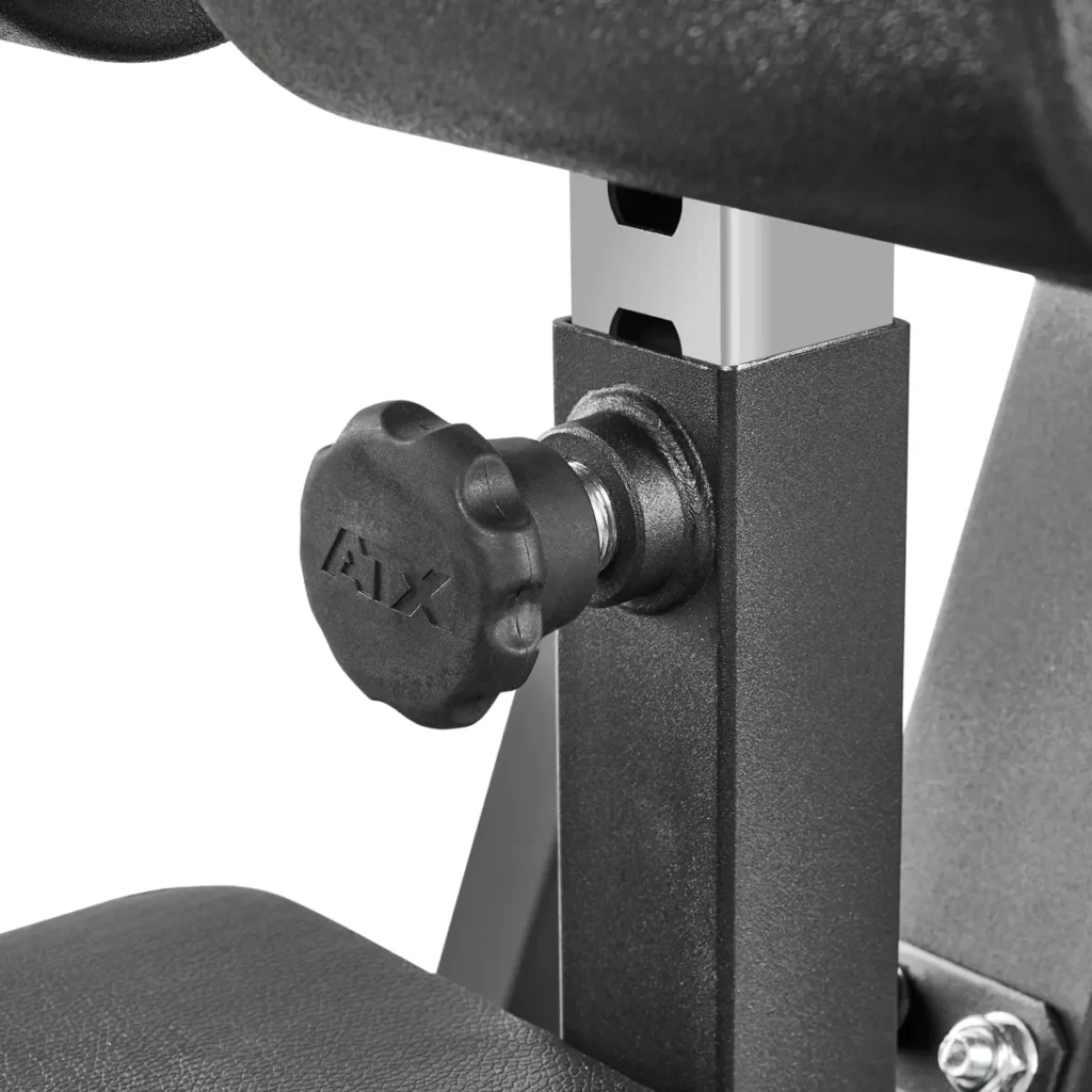 Close-up of a black adjustable knob on the ATX® Cable Lat Pull Down Machine, featuring MAX embossed on it. The knob is attached to a square metal bar, with a cushioned component visible above.