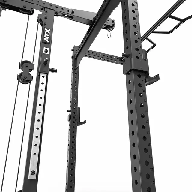Close-up of the ATX® Lat Option 780 125kg SW, a black metal power rack with multiple holes for weightlifting. It includes cables, adjustable hooks, and a plate-loaded lat pulldown attachment. The ATX logo is displayed on one of the vertical bars.