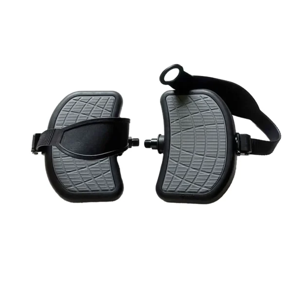 Close-up of two black and gray Spin Bike Pedal 9/16 attachments with textured surfaces. Each pedal includes an adjustable strap and a protruding connector for securing, indicating use with exercise equipment or similar devices.