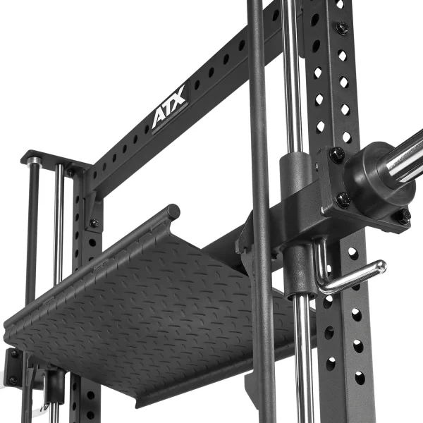 Close-up of a black ATX power rack with adjustable metal support bars and textured platform. The rack features multiple holes for height adjustment and sturdy construction for gym equipment.