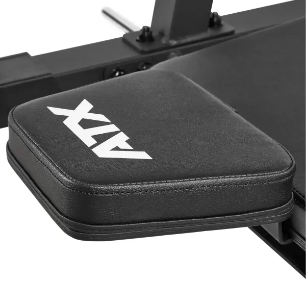Close-up of a padded black gym bench with the letters ATX printed on the surface. The bench features thick cushioning and sturdy construction, attached to a metal frame.