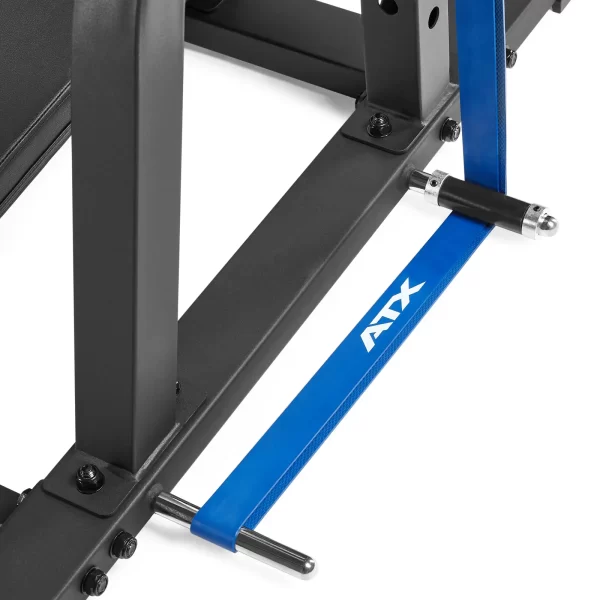 Close-up of a blue resistance band with ATX printed on it, attached to a sturdy black metal frame, likely part of a fitness bench or equipment. The band is secured at both ends with metallic holders.