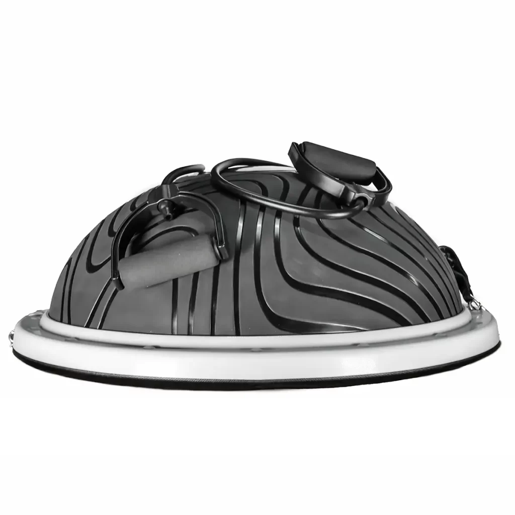 The Power Maxx Bosu Ball is a black half-ball balance trainer featuring a swirling, textured surface. It comes with a solid base and includes resistance bands with handles attached to the sides for enhanced functionality.