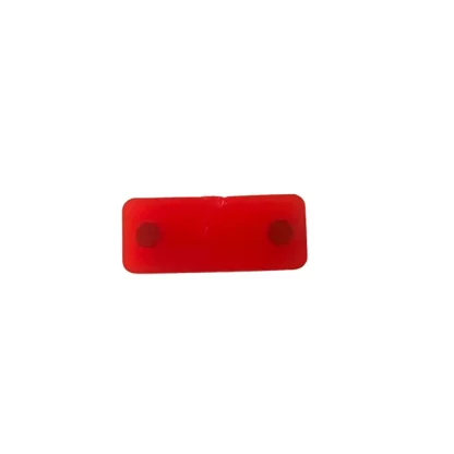Red rectangular rubber stopper for Star Trac gym equipment, featuring two mounting holes 6.7 cm apart